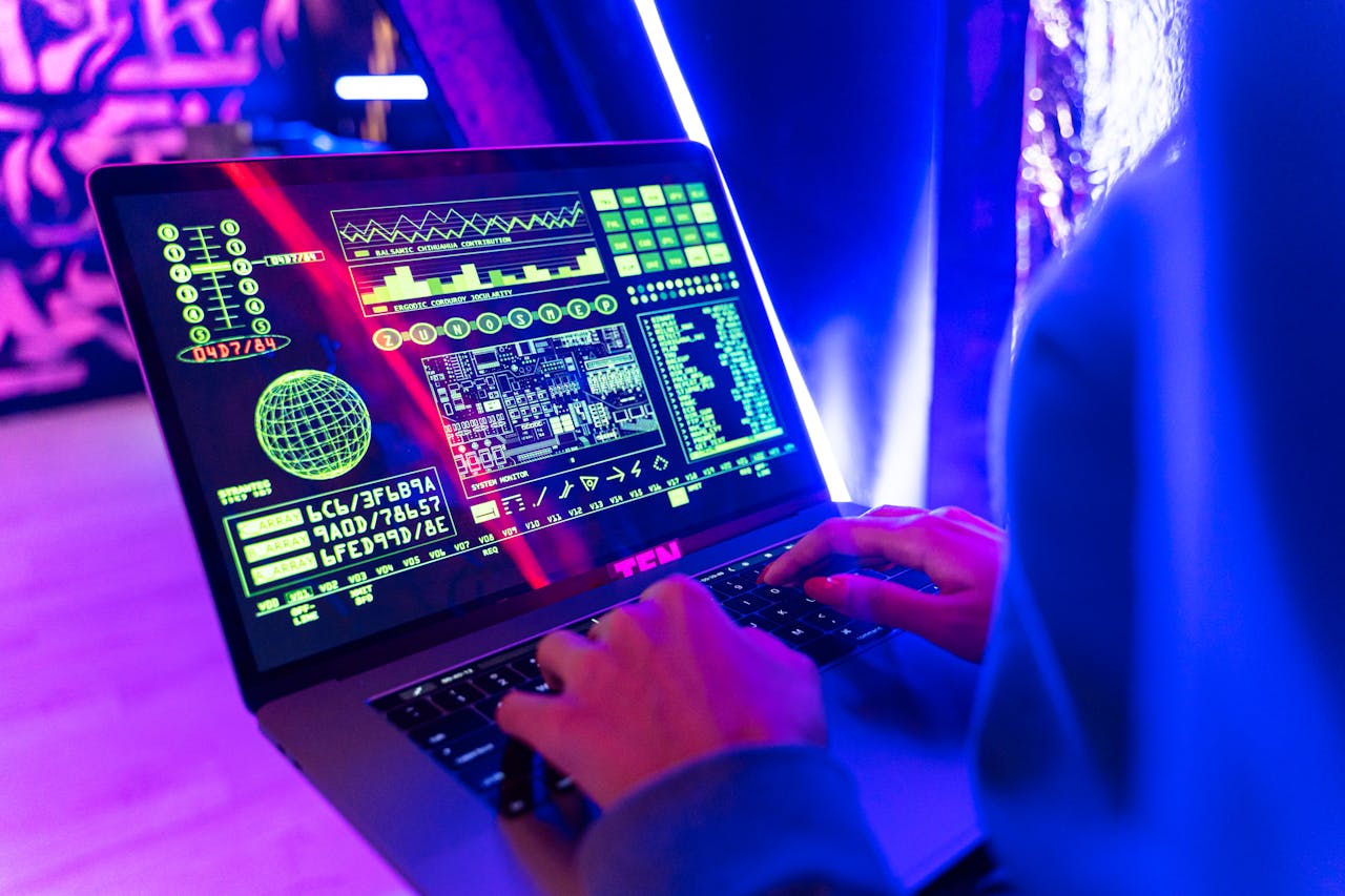 our-story Person typing on a laptop with vibrant digital data display, highlighting cyber security.